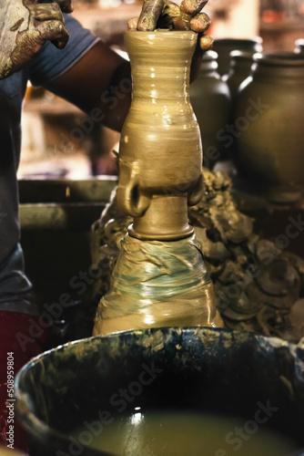 Artist's hands building ceramic pieces. photo