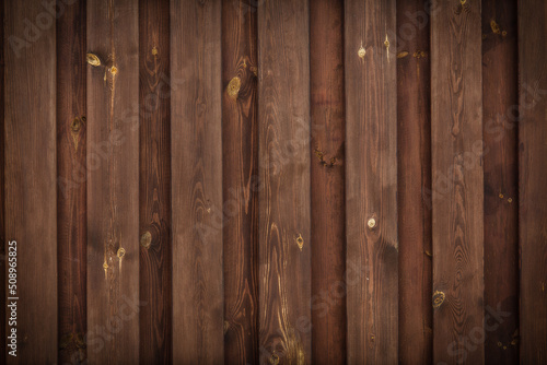 Brown wooden fence. Texture boards in the form of a rural fence.