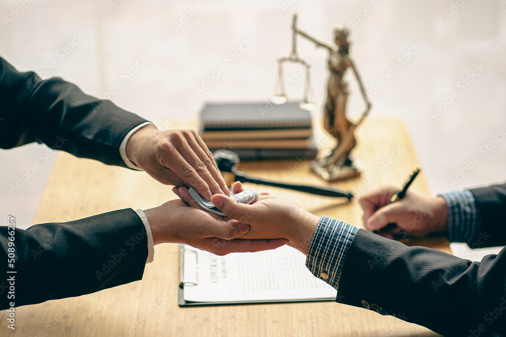Fototapeta premium When a court or lawyer receives money from a businessman in exchange for a grant Making an unjust judgment is a corruption and taking a bribe at a table with a hammer and a god of justice beside it.