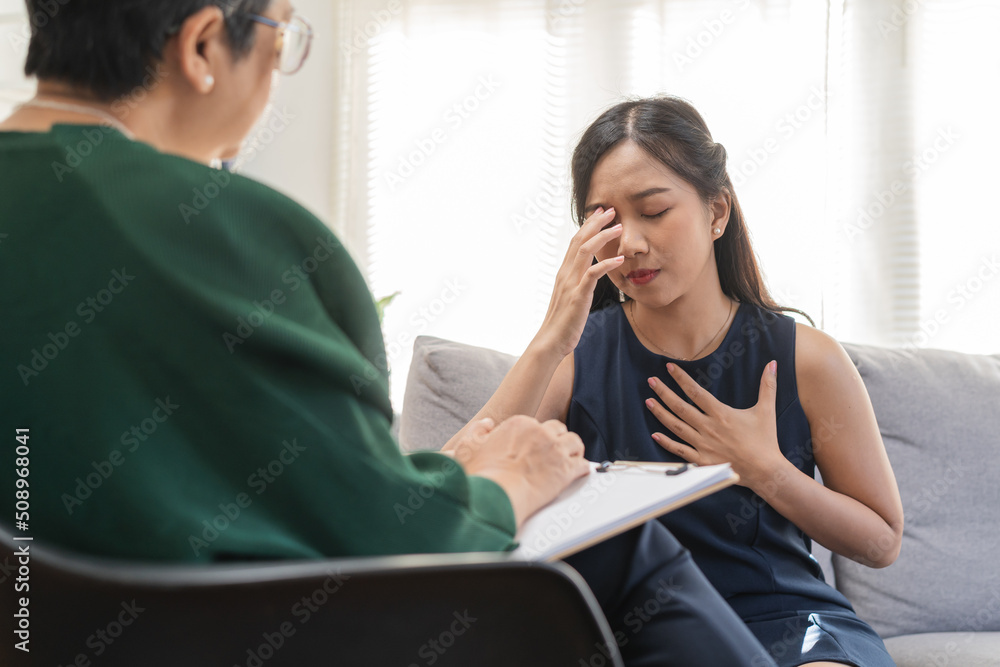 Psychology, depression. sad asian young woman cry about break up or divorce, consulting with psychologist ,psychiatrist while patient counseling mental with doctor at clinic. Encouraging, therapy.