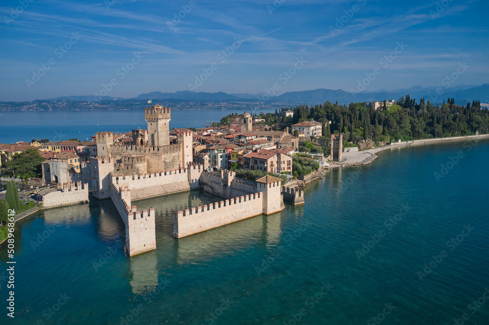 Sirmione top view. Aerial view of Sirmione, an ancient village on southern Garda Lake. Popular travel destination on Lake Garda in Italy. Scaligero Castle drone view.