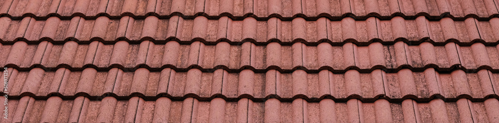 New roof with ceramic tiles, Orange roof tiles - European rounded roof-tiles, Brown terra cotta roof tiles texture and background seamless.
