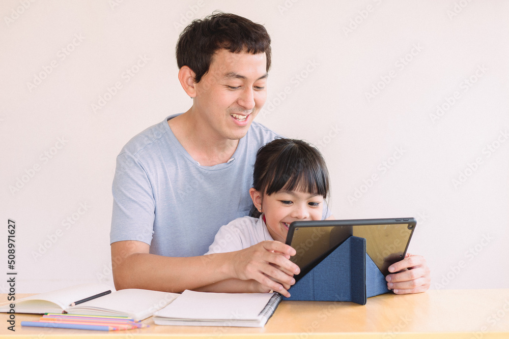 parent and child, Asian father and daughter using digital tablet holding mobile computer watch cartoons educational online program , Father's day, parent and child, Asian father and daughter using digital tablet holding mobile computer watch cartoons educational online program , Father's day,