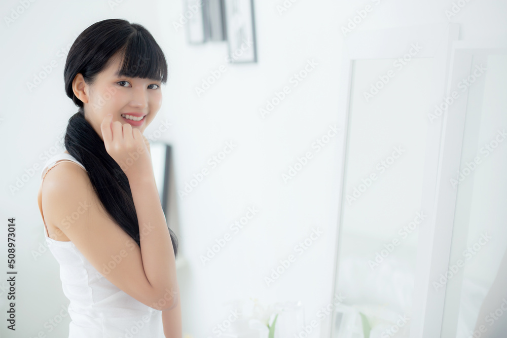 Beautiful face of young asian woman with happy smiling and touch cheek looking mirror with charming, makeup of beauty facial girl with skincare and cosmetic treatment, skin care and healthy concept. Beautiful face of young asian woman with happy smiling and touch cheek looking mirror with charming, makeup of beauty facial girl with skincare and cosmetic treatment, skin care and healthy concept.