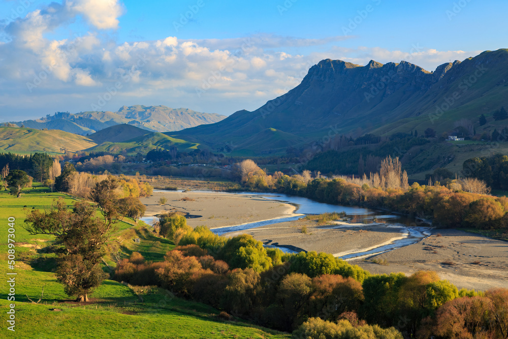 Autumn landscape in the Hawke's Bay region, New Zealand.  The Tukituki River passes by Te Mata Peak, the mountain to the right