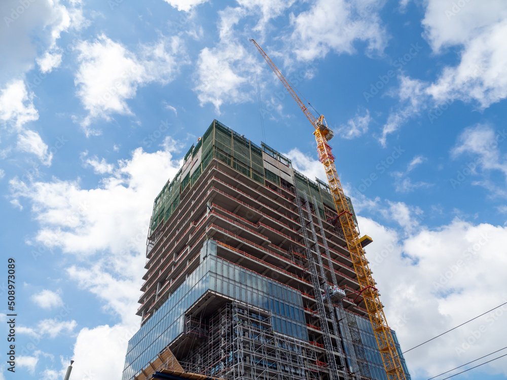 Construction. Tower crane at the construction site of a high-rise building. Construction. Tower crane at the construction site of a high-rise building.