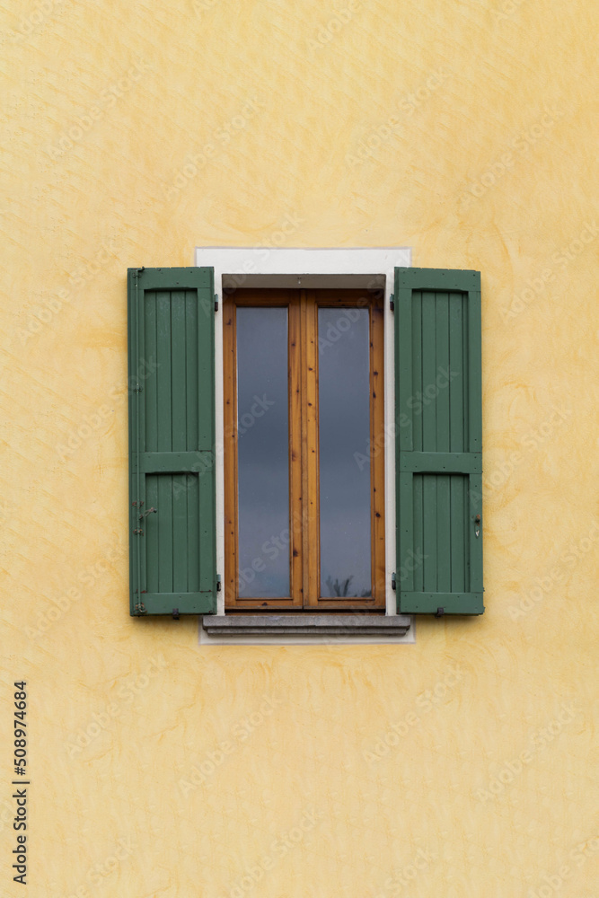 Traditional window of Italian house with closing doors in wood