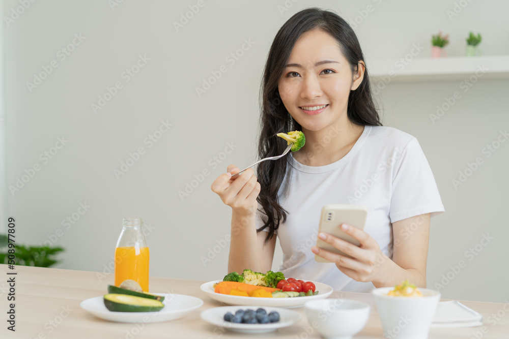 young female planning menu to eat ketogenic diet during weight loss program.