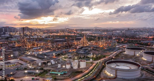 Aerial Hyperlapse Time-lapse of the refinery and oil tank at dusk. Business and petrochemical plants, oil storage tanks, and energy and steel pipes in Twilight time