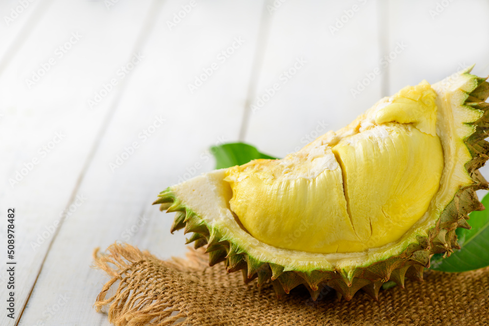 Durian and durian peels (monthong) on sack and old wood background, Durian and durian peels (monthong) on sack and old wood background,