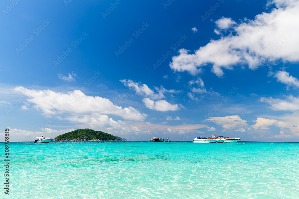 Speed boat on clear sea with white cloudy and blue sky at Similan Island, phang-nga Thailand,