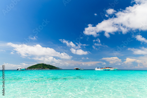 Speed boat on clear sea with white cloudy and blue sky at Similan Island, phang-nga Thailand,