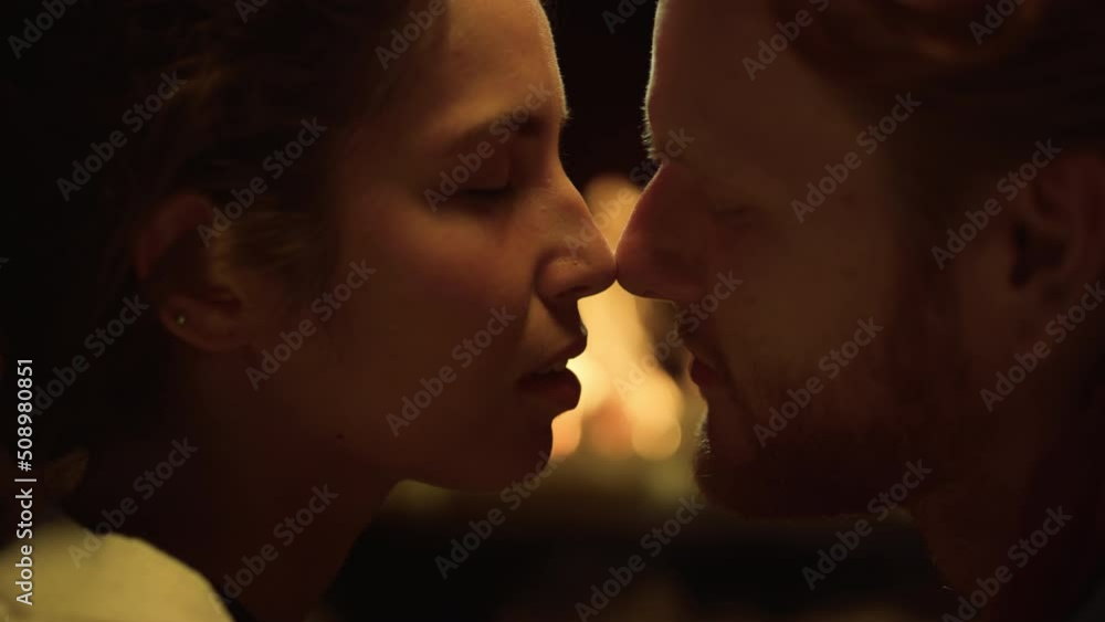 Authentic married couple kissing in cozy house fireplace. Two lovers enjoy date. Authentic married couple kissing in cozy house fireplace. Two lovers enjoy date.