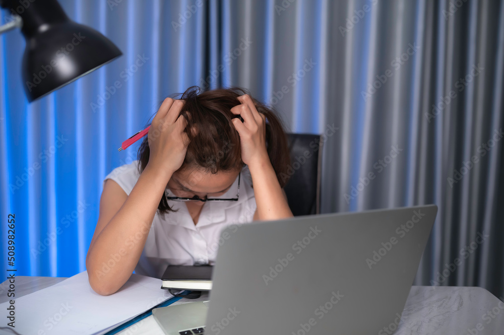 Beautiful asian woman working at home on the night,A lot of work from company,bring home work,Work from home Beautiful asian woman working at home on the night,A lot of work from company,bring home work,Work from home
