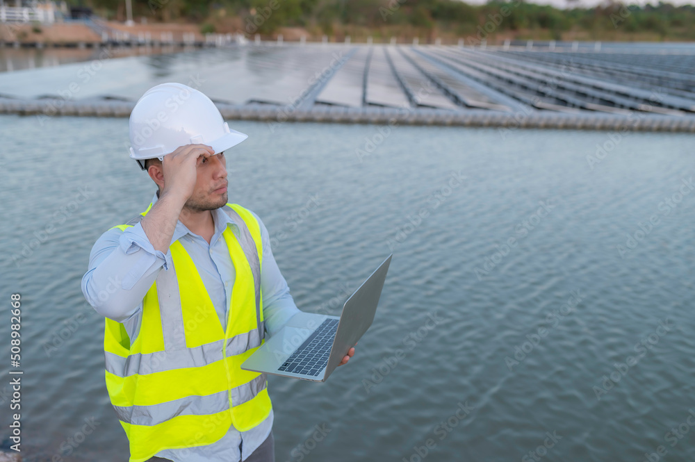 Asian engineer working at Floating solar farm,Renewable energy,Technician and investor solar panels checking the panels at solar energy installation Asian engineer working at Floating solar farm,Renewable energy,Technician and investor solar panels checking the panels at solar energy installation