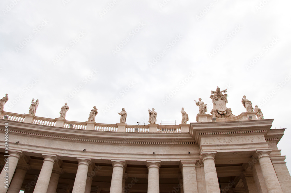 Architectural detail of st peters basilica colonnade with statues standing on columns