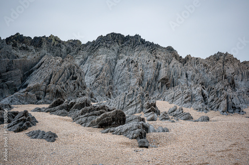 Slate, quartz and sandstone rock formations at Barricane Beach, Woolacombe, Devon photo
