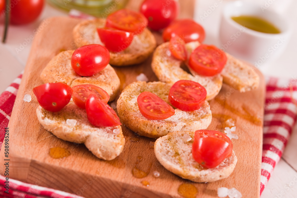 Friselle with cherry tomatoes and olive oil.