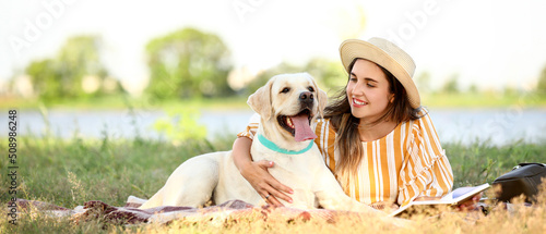 Woman with cute Labrador re...