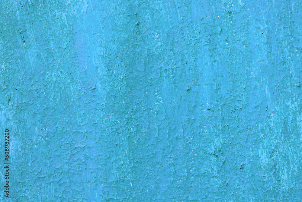 Beautiful vintage blue background with old blue paint with a rough surface, streaks and uneven texture of blue paint on an old rough surface
