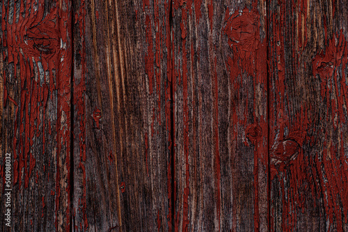 Old natural weathered wooden planks with cracked red paint background