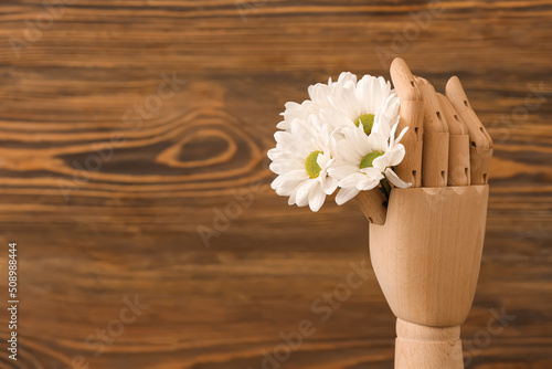 Wooden hand with chrysanthe...