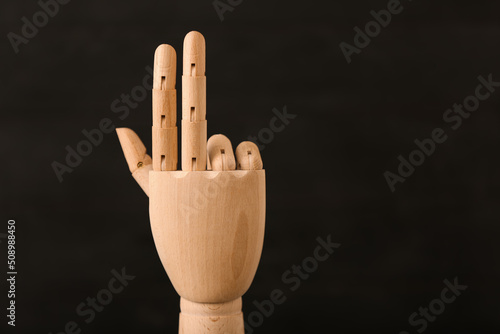 Wooden hand on black backgr...