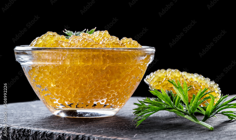 Pike caviar or roe in the bowl on wooden background. Pike caviar or roe in the bowl on wooden background.