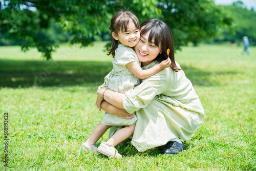 mother and her daughter hugging in the park