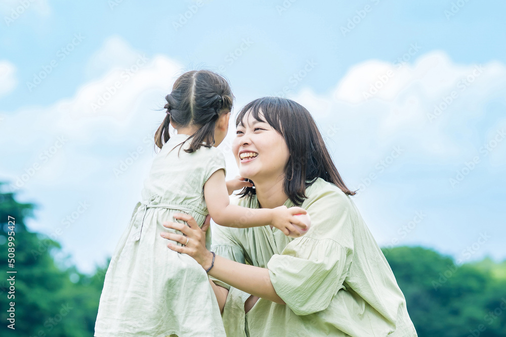 mother and her daughter hugging in the park mother and her daughter hugging in the park