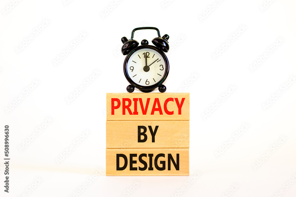 Privacy by design symbol. Concept words Privacy by design on wooden blocks on a beautiful white table white background. Black alarm clock. Business, finacial and privacy by design concept. Copy space. Privacy by design symbol. Concept words Privacy by design on wooden blocks on a beautiful white table white background. Black alarm clock. Business, finacial and privacy by design concept. Copy space.