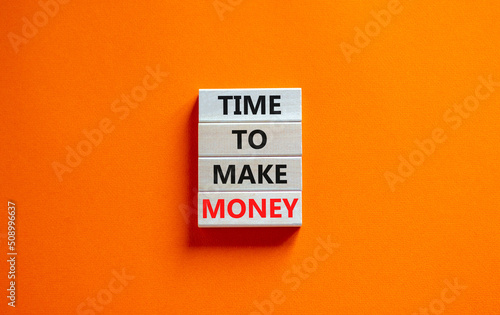 Time to make money symbol. Concept words Time to make money on wooden blocks on a beautiful orange table orange background. Business, finacial and time to make money concept.