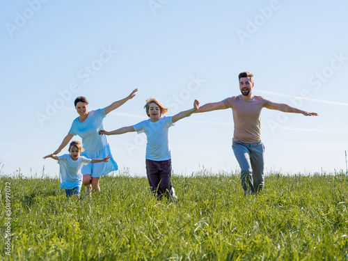 Happy family running on grass