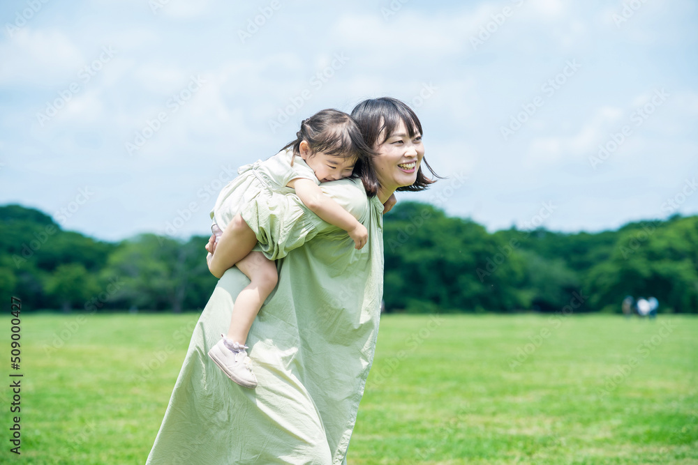 mother and her daughter playing in the park mother and her daughter playing in the park