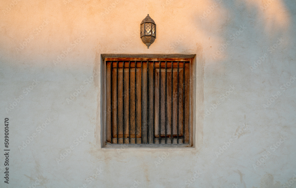 background image of old window and old wall lamp in qatar.. Arabic style