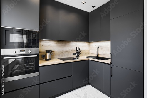 Electrical appliances and black cabinets in empty kitchen