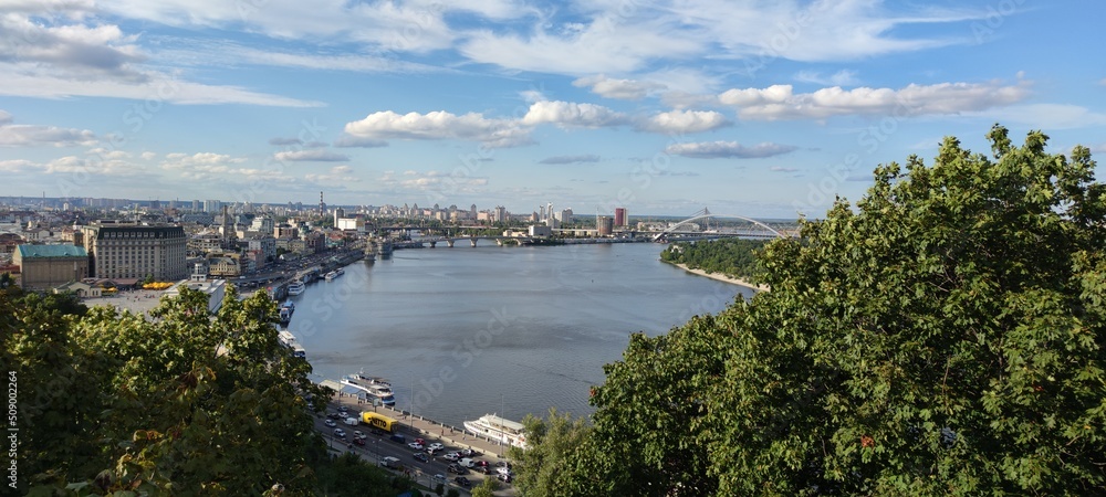 The beautiful Ukrainian city of Kyiv in the palm of your hand. Wonderful view of the embankment, houses, roads, river.