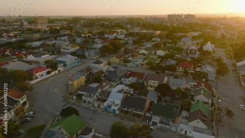 Dense development of family houses in residential neighbourhood. Fly above town at sunset. Port Elisabeth, South Africa