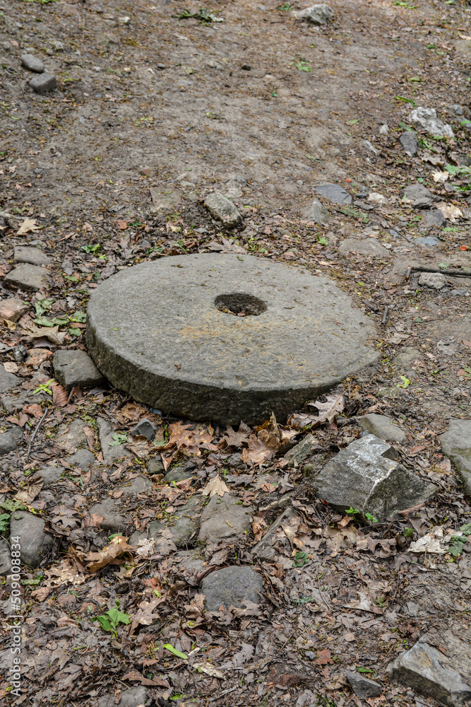 Photo of a large stone millstone from the mill .