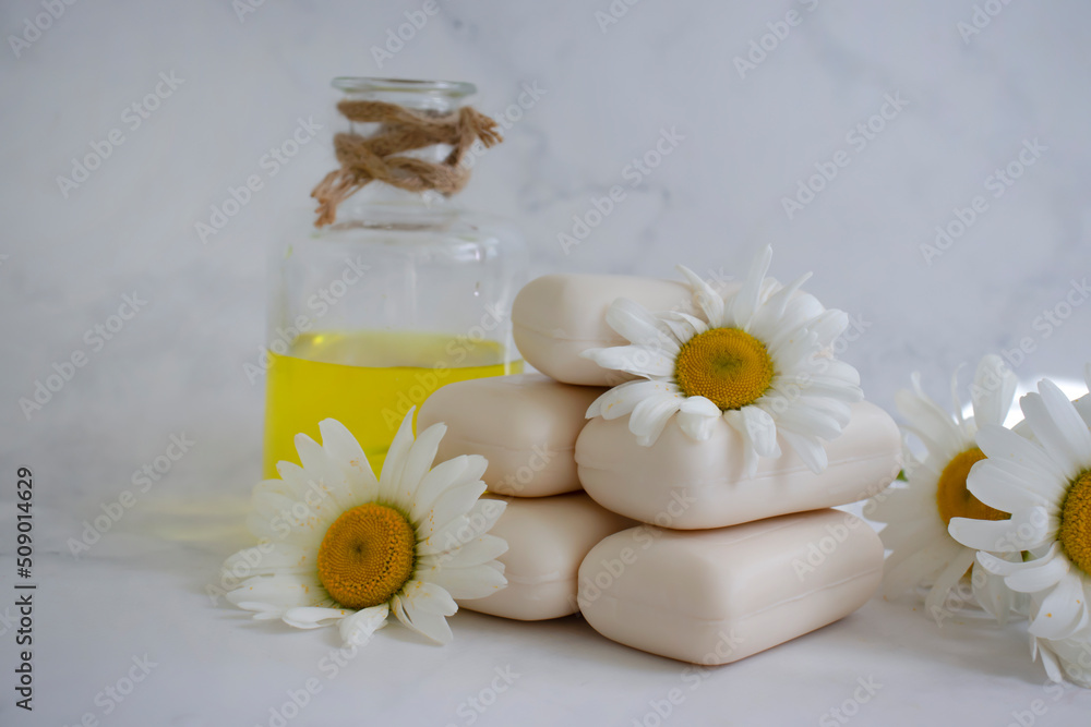 natural soap, chamomile flower on a light background natural soap, chamomile flower on a light background