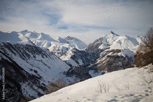 Alpine winter mountain landscape. French Alps covered with snow in sunny day. 