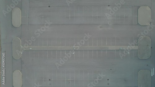 flying from above on a drone empty shopping mall parking lot asphalt summer at sunset. High quality 4k footage