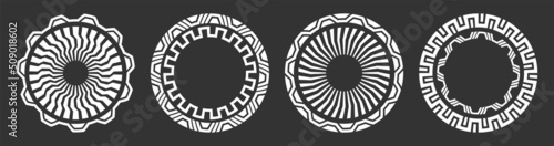 Set of four abstract circular ornaments. Decorative patterns isolated on black background. Tribal ethnic motifs. Mechanical elements, details. Stencil tattoo and prints. Vector monochrome illustration