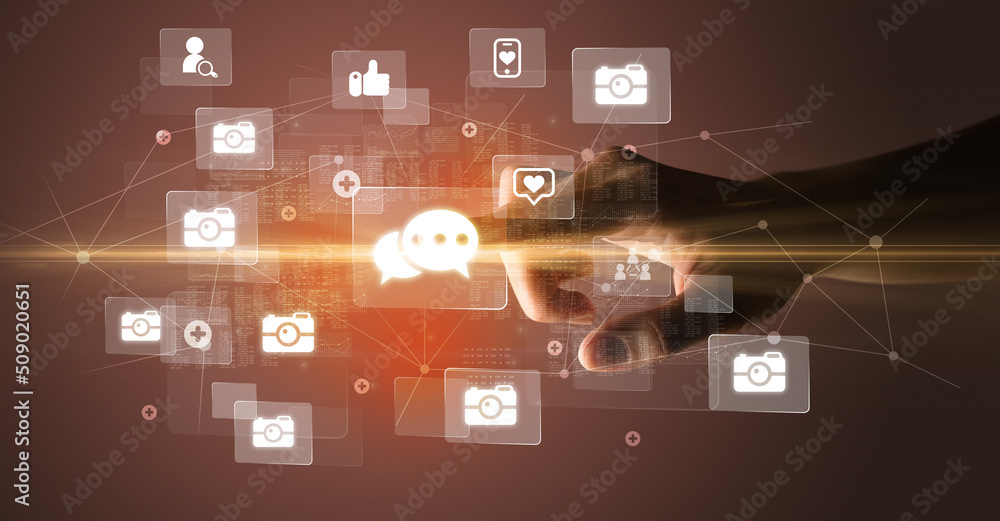 Hand pressing social media multimedia application screen with media icons on futuristic concept Hand pressing social media multimedia application screen with media icons on futuristic concept