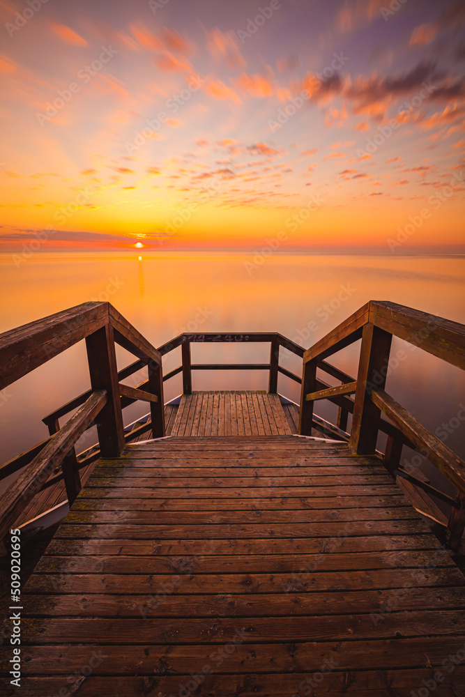 Fototapeta premium sunset at the pier in Mechelinki. Baltic Sea