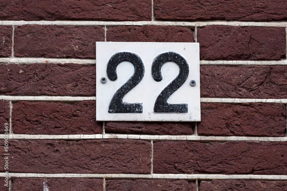 House number sign on a brick wall House number sign on a brick wall