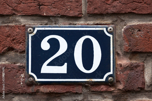 House number sign on a brick wall