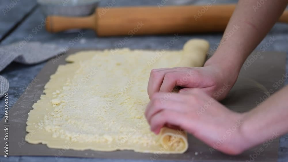 Female Hands Rolling Dough into Rolls, Baking Process Making Buns. Female Hands Rolling Dough into Rolls, Baking Process Making Buns.