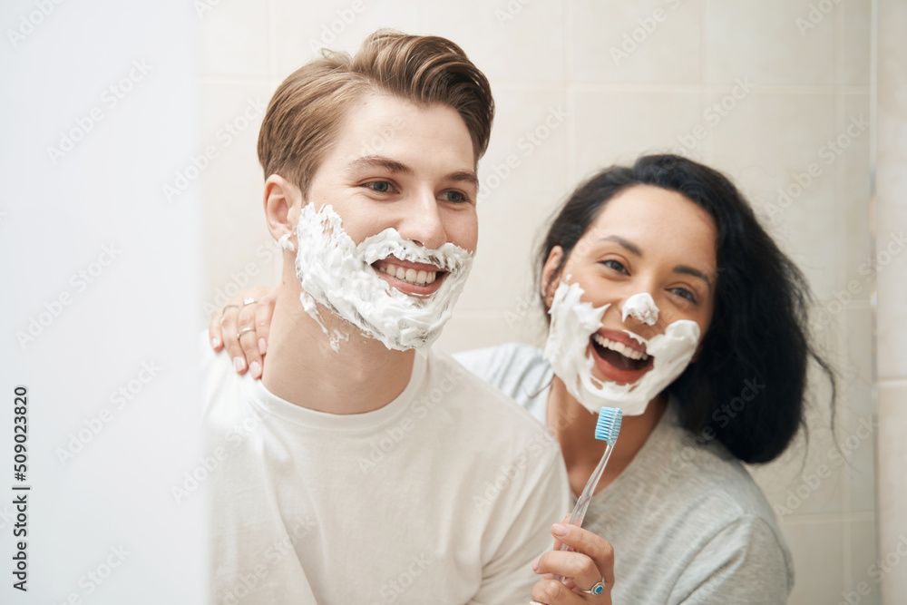 Couple having fun during morning routine in bathroom