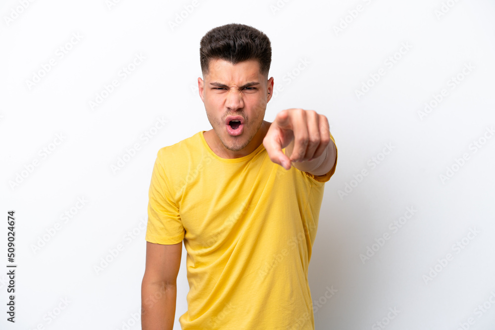 Young caucasian man isolated on white background frustrated and pointing to the front Young caucasian man isolated on white background frustrated and pointing to the front